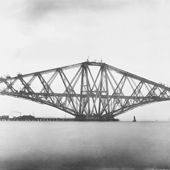 Photograph showing a broadside view the Queensferry cantilever of the Forth Railway Bridge in an advanced stage of construction, May 1889 (Crown Copyright, National Records of Scotland, BR/FOR/4/34/5)