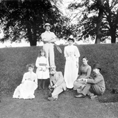Photograph of a group of three women, a child and three men posed on a small bank. The man on on the right of the group is Forth Bridge designer Benjamin Baker, July 1888 (Crown Copyright, National Records of Scotland, BR/FOR/4/34/68)