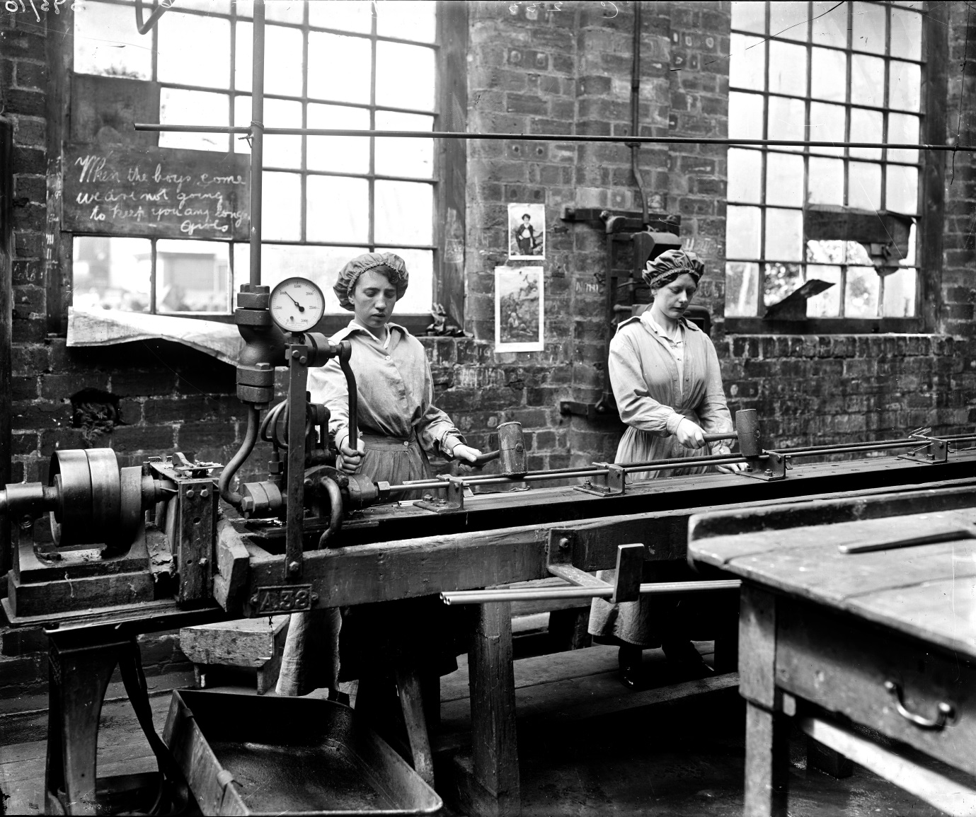 Women workers testing condenser tubes at John Brown & Co's yard at Clydebank. Hostility to women 'dilutees' is evidence in the chalked message, 'When the boys come [back] we are not going to keep you any longer girls', National Records of Scotland (archive reference: UCS1/118/Gen/393/10)